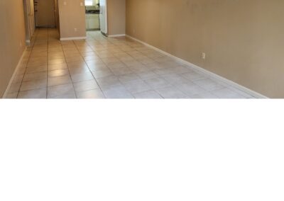 Spacious interior of a first-floor condo in West Little Rock, featuring tiled flooring and an open layout leading to the kitchen area.