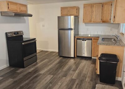 Newly renovated kitchen in Midtown Little Rock duplex, featuring modern appliances, granite countertops, and contemporary cabinetry.