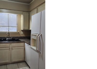 Updated kitchen featuring white appliances, granite countertops, and a window providing natural light, emphasizing modern living in a first-floor condo in West Little Rock.
