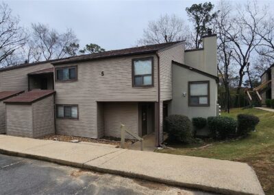 First-floor condominium in Pleasant Woods community, featuring a modern exterior, landscaped surroundings, and convenient access in West Little Rock.