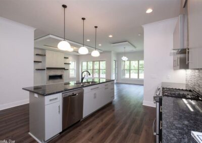 Modern kitchen in a smart home featuring stainless steel appliances, granite countertops, and an open layout with natural light from large windows, ideal for contemporary living in West Little Rock.