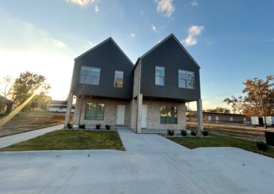 Brand-new high-end townhome in the Argenta District, featuring modern architecture, dual gabled roofs, and a landscaped front yard.