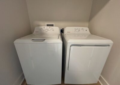 Full-size washer and dryer in a modern townhome laundry area, featuring a sleek design and efficient layout.
