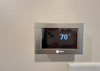 Thermostat displaying 70°F in a modern townhome, reflecting the high-end amenities and comfort of the Argenta District rental property.