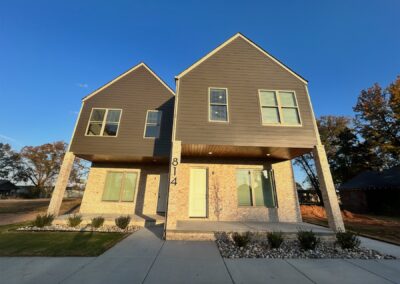 Brand new townhome in Argenta District with modern architecture, featuring a two-story design, large windows, and stone accents.