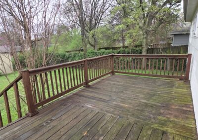 Spacious wooden deck overlooking a fully fenced yard, ideal for outdoor relaxation and entertaining, part of a fully renovated home in Midtown Little Rock.