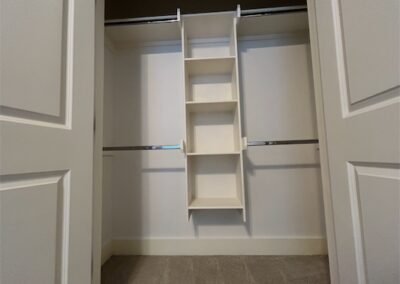 Spacious closet with built-in shelving and hanging rods in a Benton, Arkansas townhome rental.