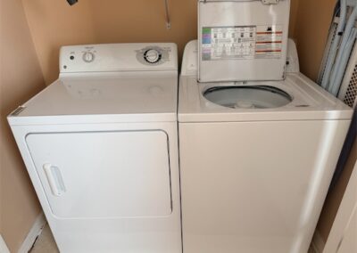 Washer and dryer set in a laundry area, showcasing essential appliances included in the spacious West Little Rock home listing.