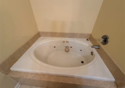 Spacious West Little Rock home featuring a large jacuzzi tub in a neutral-toned bathroom.