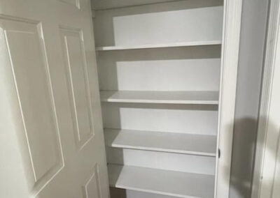 Interior view of a spacious white pantry with multiple shelves, showcasing ample storage for a single-family home in West Little Rock, available for rent.