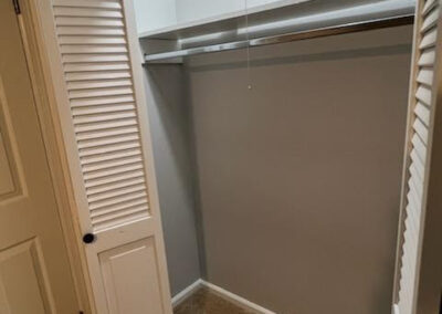 Spacious closet with sliding doors and neutral gray walls in a single-family home for rent in West Little Rock.